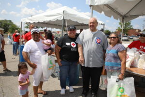 Town President Larry Dominick and American Red Cross regional director Joy Medrano pose with homeowners who received post-flood assistance packages July 18, 2023